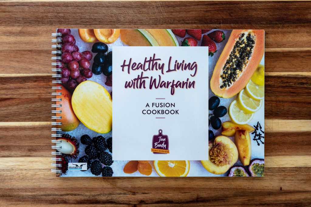 Healthy Living With Warfarin book on wooden background